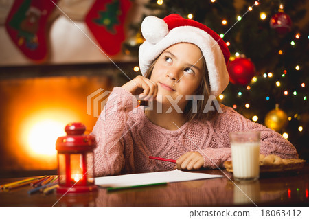 girl thinking of letter to Santa at living room girl thinking of letter to Santa at living room 18063412