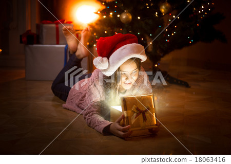 girl on floor looking inside of magic gist box 18063416
