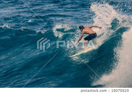 Extreme surfer riding giant ocean wave in Hawaii 18070820
