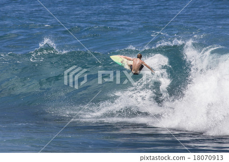 Extreme surfer riding giant ocean wave in Hawaii 18070913
