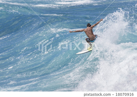 Extreme surfer riding giant ocean wave in Hawaii Extreme surfer riding giant ocean wave in Hawaii 18070916