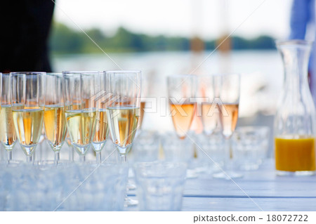Glasses with champagne and wine on summer wedding 18072722