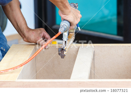 carpenter use air-gun for make new furniture carpenter use air-gun for make new furniture 18077321