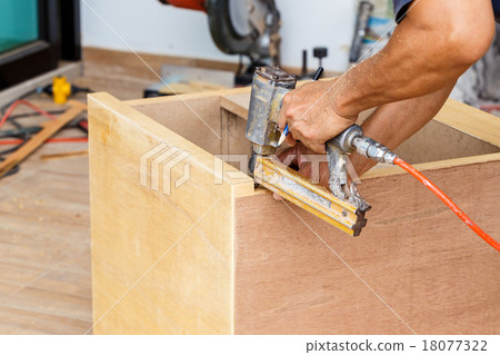 carpenter use air-gun for make new furniture carpenter use air-gun for make new furniture 18077322