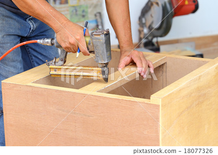 carpenter used air-gun for make new furniture 18077326