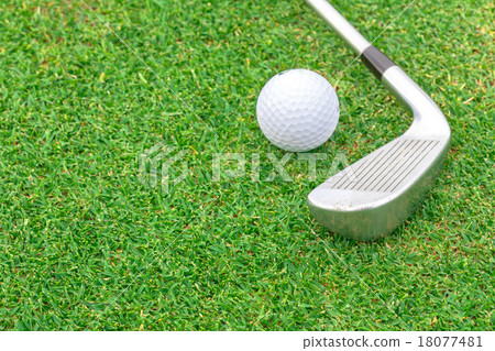 golf ball on tee in front of driver green course 18077481