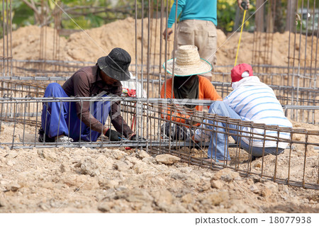 worker bending steel for construction job worker bending steel for construction job 18077938