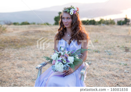 Attractive bride is holding a wedding bouquet 18081838