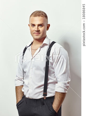 Portrait of handsome young man in white shirt and suspenders 18086845