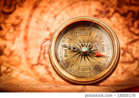 Vintage compass lies on an ancient world map. 18088176