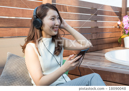 A woman listening to music A woman listening to music 18090048