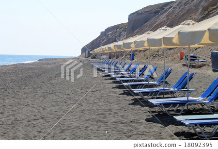 empty sunbeds on the beach, Santorini, Greece 18092395