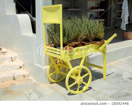 old cart with flowers on street in Oia, Santorini 18092446