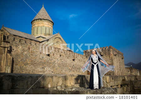 beautiful young Georgian girl near old castle 18101401