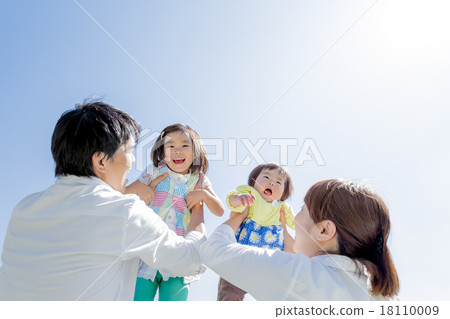Four people playing on the green hills of the park 18110009