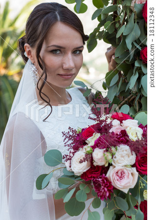 Beautiful bride outdoors with a bouquet Beautiful bride outdoors with a bouquet 18112348
