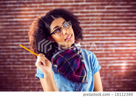 Daydreaming attractive hipster holding pen Daydreaming attractive hipster holding pen 18112389