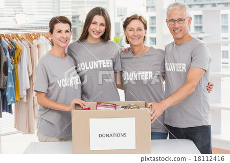 Smiling volunteers putting arms around each other 18112416