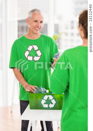 Smiling eco-minded man with recycling box 18112440