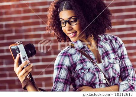 Attractive hipster taking selfies with camera 18112613
