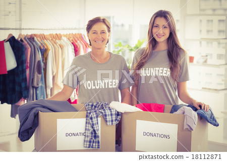 Concerned businesswomen with donation boxes Concerned businesswomen with donation boxes 18112871