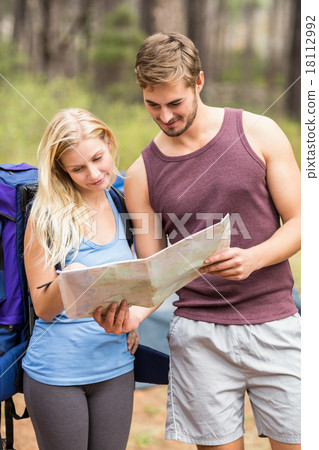 Young happy joggers looking at map Young happy joggers looking at map 18112992