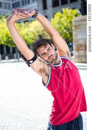 Handsome athlete doing arms stretching 18113008