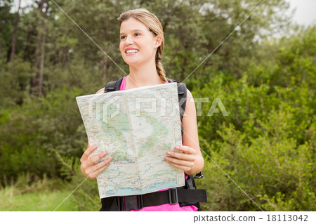 Smiling blonde hiker with map 18113042