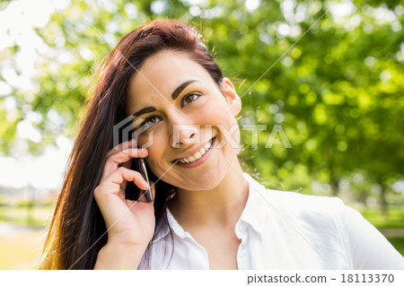 Beautiful brunette in the park making a call 18113370