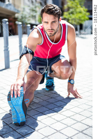 Handsome athlete doing leg stretching 18113462