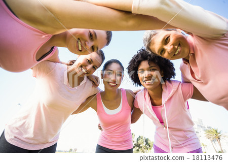 Women wearing pink for breast cancer with arms around 18113476