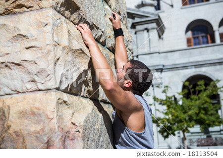 Extreme athlete gripping to wall 18113504