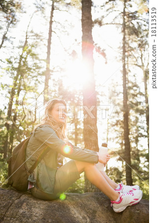 Pretty blonde hiker sitting on stone Pretty blonde hiker sitting on stone 18113519