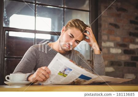 Handsome man having coffee and reading newspaper 18113685
