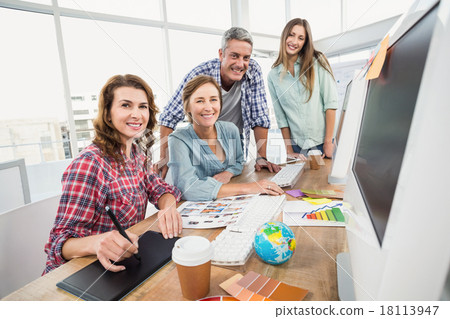 Stock Photo: Casual business team having a meeting using a computer