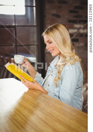 Smiling blonde having coffee and reading book 18113969
