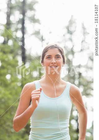 Happy jogger running and listening to music Happy jogger running and listening to music 18114107