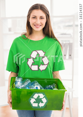 Smiling eco-minded brunette holding recycling box 18114337