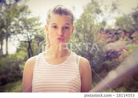 Pretty blonde sending kiss and taking selfies with selfiestick 18114353