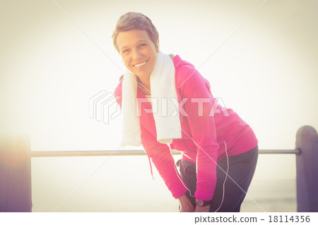 Smiling sporty woman listening to music Smiling sporty woman listening to music 18114356
