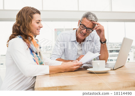 Two smiling casual designers brainstorming Two smiling casual designers brainstorming 18114490