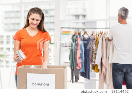 Casual business colleagues sorting donations Casual business colleagues sorting donations 18114492