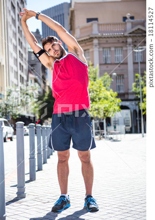 Handsome athlete doing arms stretching 18114527