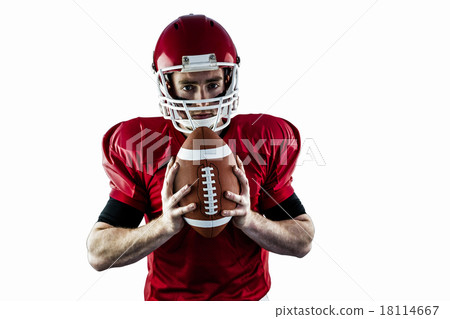 Portrait of focused american football player holding football Portrait of focused american football player holding football 18114667