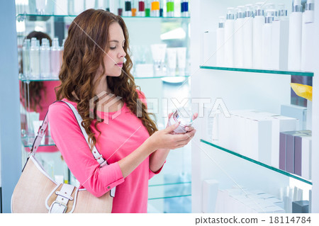 Pretty woman shopping for cosmetics 18114784