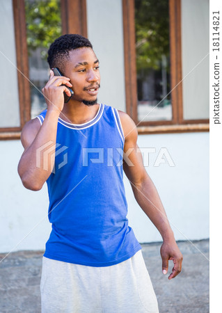 An happy handsome athlete calling An happy handsome athlete calling 18114821