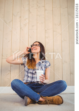 Pretty hipster on the phone holding cup 18115018