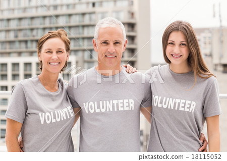 Smiling volunteers putting arms around each other Smiling volunteers putting arms around each other 18115052