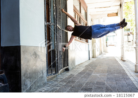 Man doing parkour in the city Man doing parkour in the city 18115067