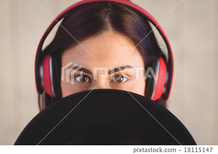 Pretty hipster listening to music holding vinyl Pretty hipster listening to music holding vinyl 18115147
